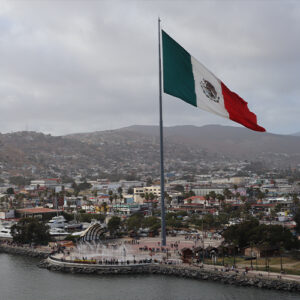 The Mexican flag flies on a windy day at the Port of Ensenada as seen from the Carnival Radiance in Ensenada Mexico - Cruise with Charles